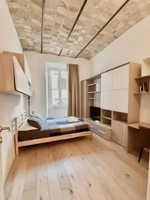 a bedroom with a bed in the middle of a room at Ovidio Luxury in Rome