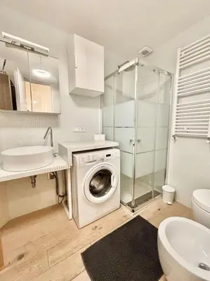 a bathroom with a washing machine and a sink at Ovidio Luxury in Rome