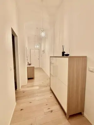 a white room with a counter and a hallway at Ovidio Luxury in Rome