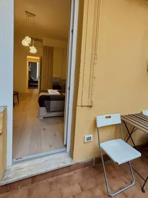 a hallway with a chair and a living room at Ovidio Luxury in Rome