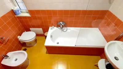 a bathroom with a tub and a toilet and a sink at San Martino Home in Rome
