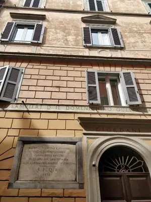 a building with a door and a sign on it at San Martino Home in Rome