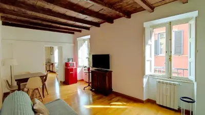a living room with a couch and a television and a table at San Martino Home in Rome