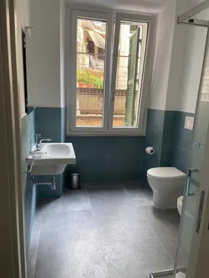 a bathroom with a sink and a toilet and a window at Air Vatican in Rome