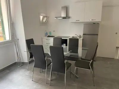 a kitchen with a glass table and chairs in it at Air Vatican in Rome