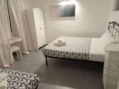 a small bedroom with a bed and a chair at Air Vatican in Rome