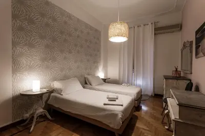 a bedroom with a bed and a table and a lamp at 