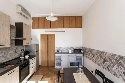 a kitchen with wooden cabinets and a table in it at 