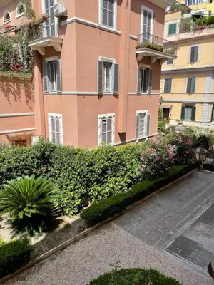 an apartment building with plants in front of it at 