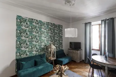 a living room with a green couch and a table at 