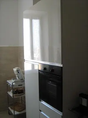 a kitchen with a refrigerator and a microwave at Appia Nuova Holiday B&B in Rome