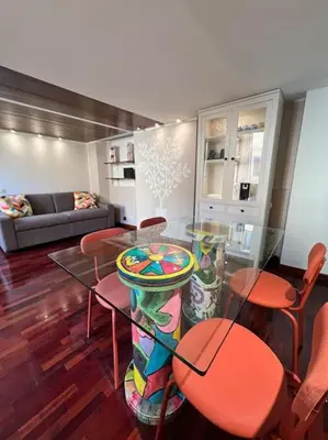 a living room with a glass table and chairs at Torre Argentina Apartment in Rome