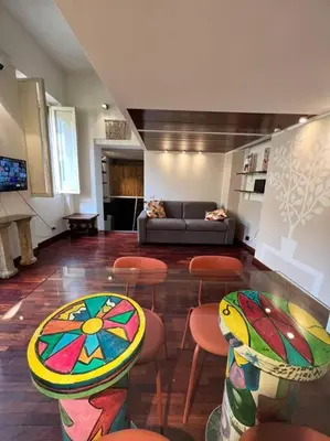 a living room with a couch and tables and chairs at Torre Argentina Apartment in Rome