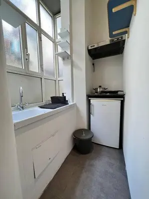 a small kitchen with a sink and a window at Torre Argentina Apartment in Rome