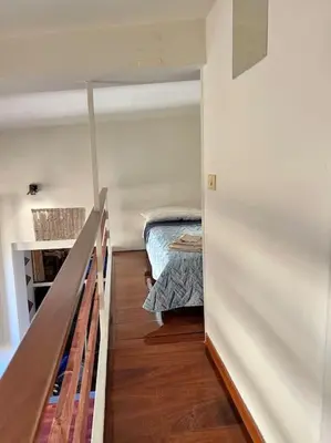 a small room with a bed and a stair case at Torre Argentina Apartment in Rome