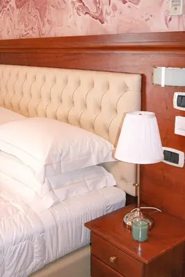 a bedroom with a bed with a lamp and a table at Monti 66 Hotel in Rome