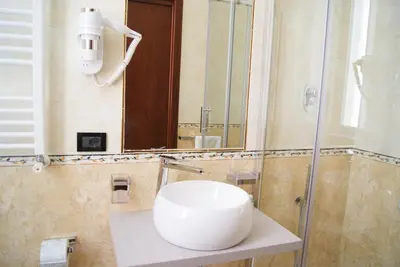 a bathroom with a white sink and a shower at Monti 66 Hotel in Rome