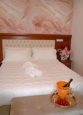 a bed with a bowl of fruit and a plate of towels at Monti 66 Hotel in Rome