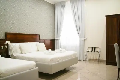 a hotel room with two beds and a window at Monti 66 Hotel in Rome