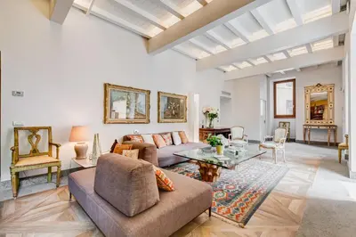 a living room with a couch and a table at BMGA l Luxury Home with Patio in Trastevere in Rome