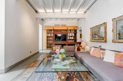 a living room with a couch and a table at BMGA l Luxury Home with Patio in Trastevere in Rome