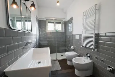 a white bathroom with a sink and a toilet at 15 MIN FROM THE VATICAN Wi-fi and garden in Rome