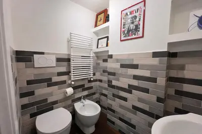 a bathroom with a white toilet and a sink at 15 MIN FROM THE VATICAN Wi-fi and garden in Rome