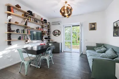 a living room with a table and a couch at 15 MIN FROM THE VATICAN Wi-fi and garden in Rome