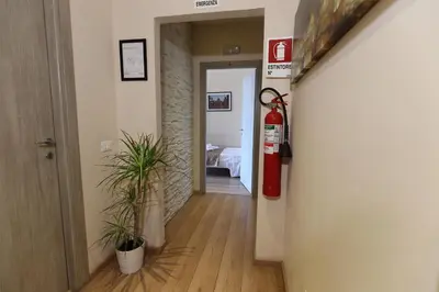 a hallway with a fire hydrant and plants in a room at Aria Rome Rooms in Rome