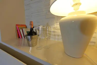 a table with a bottle of wine and glasses on it at Aria Rome Rooms in Rome