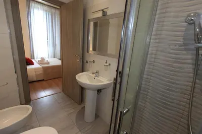 a bathroom with a sink and a shower at Aria Rome Rooms in Rome