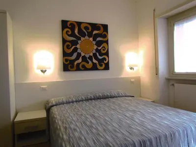 a bedroom with a bed and a painting on the wall at Buonarroti Guest House in Rome