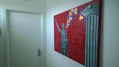 a painting of a woman on a wall next to a door at Buonarroti Guest House in Rome