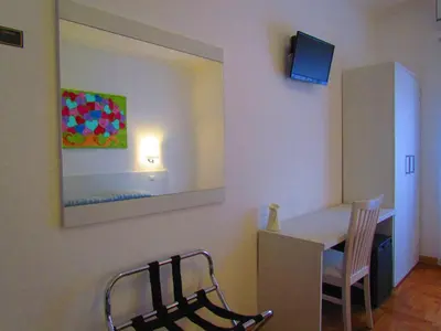 a room with a table and chairs and a mirror at Buonarroti Guest House in Rome