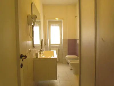 a bathroom with a sink and a toilet at Buonarroti Guest House in Rome