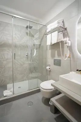 a bathroom with a shower and a toilet and a sink at Charm&Bella GuestHouse in Rome