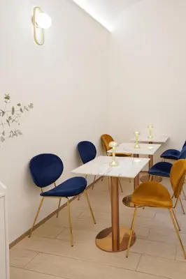 a room with two tables and blue chairs at Charm&Bella GuestHouse in Rome