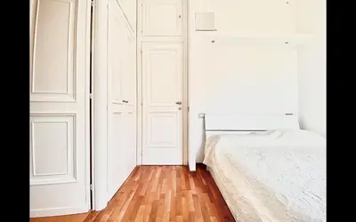 a bedroom with white cabinets and a bed at Charming mini apartment near Vatican with parking in Rome