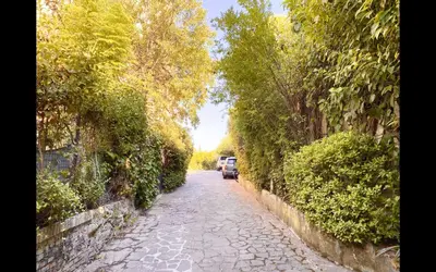 a cobblestone street with a car parked on the side at Charming mini apartment near Vatican with parking in Rome