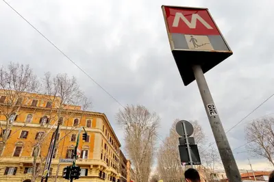 a sign on a pole on a city street at Blue Suite Vatican Guesthouse in Rome