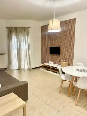 a living room with a table and a tv at Inn Trastevere in Rome