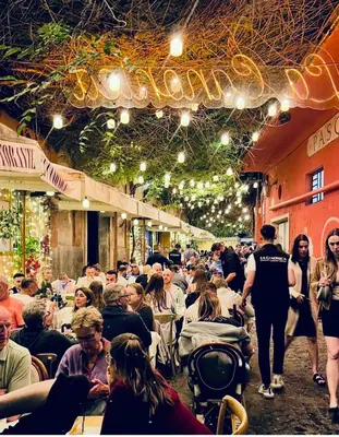 a crowd of people sitting at tables in a building at Inn Trastevere in Rome