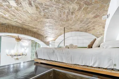 a bedroom with a bed in a room with a ceiling at LOFT49 in Rome
