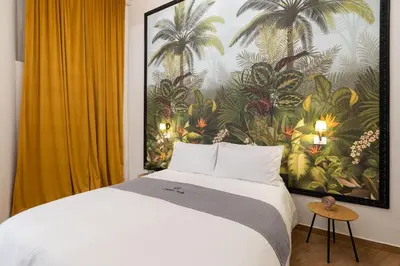 a bedroom with a large bed with a painting on the wall at Rhome_Hub in Rome
