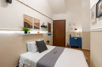 a bedroom with a large white bed in a room at Rhome_Hub in Rome