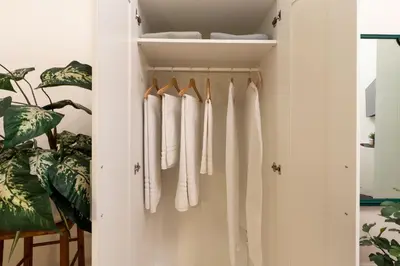 a closet with white towels hanging in it at Rhome_Hub in Rome