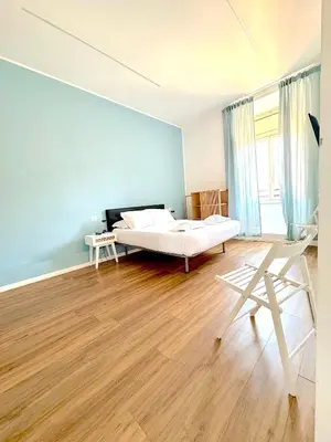 a bedroom with a bed and a table and chairs at Lexie Suites in Rome