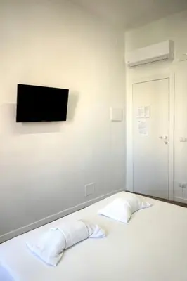 a bedroom with two beds and a window at Lexie Suites in Rome