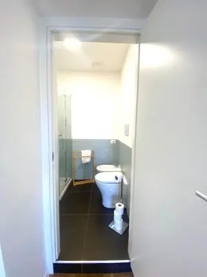 a bathroom with a toilet and a shower at Lexie Suites in Rome