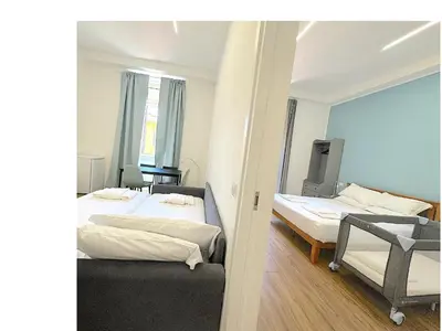 a white bedroom with a bed and a mirror at Lexie Suites in Rome